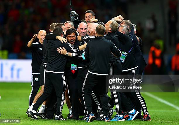 Manager Chris Coleman and Wales team staffs celebrate their team's 3-1 win after the UEFA EURO 2016 quarter final match between Wales and Belgium at...