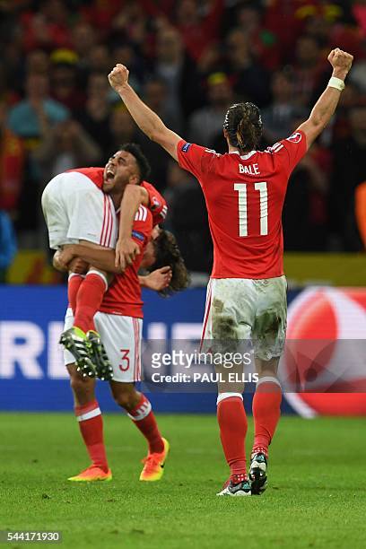 Wales' forward Gareth Bale celebrates with team mates after the Euro 2016 quarter-final football match between Wales and Belgium at the Pierre-Mauroy...