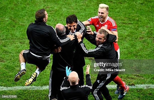 Manager Chris Coleman and Wales team staffs celebrate their team's 3-1 win with Aaron Ramsey after the UEFA EURO 2016 quarter final match between...