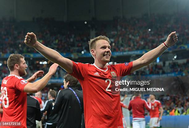 Wales' defender Chris Gunter celebrates at the end of the Euro 2016 quarter-final football match between Wales and Belgium at the Pierre-Mauroy...