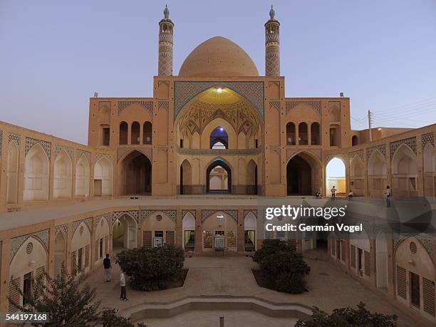 silk road mosque and madrasa architecture at dusk - isfahan stock-fotos und bilder