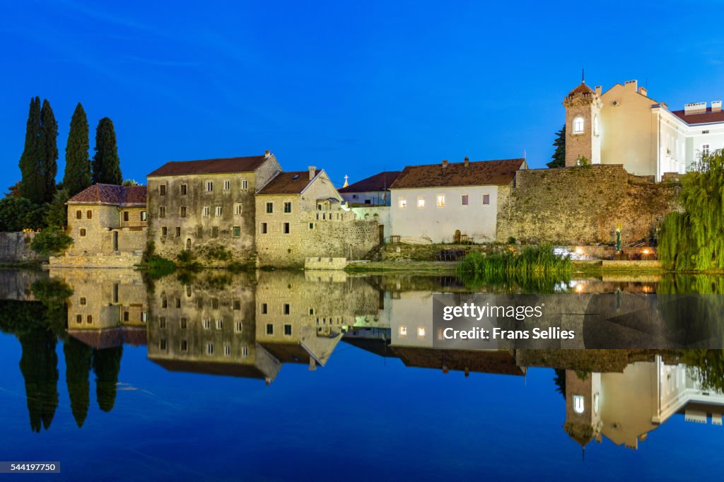 Trebinje reflected in the Trebišnjica river at night, Bosnia and Herzegovina