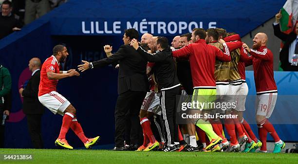 Wales captain Ashley Williams celebrates his goal with manager Chris Coleman and team mates during the UEFA Euro 2016 Quarter Final match between...