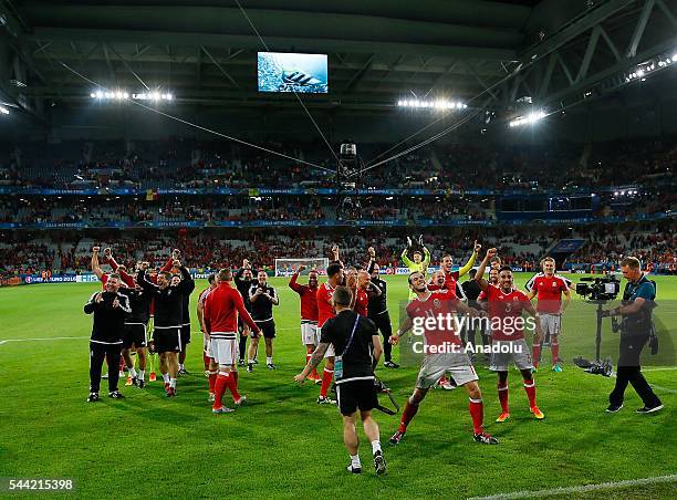 Players of Wales celebrate the victory following the UEFA Euro 2016 quarter final match between Wales and Belgium at Stade Pierre-Mauroy on July 1,...