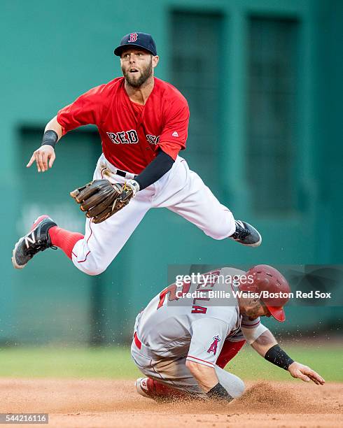 Dustin Pedroia of the Boston Red Sox turns a double play as Johnny Giovotella of the Los Angeles Angels of Anaheim slides during the second inning of...