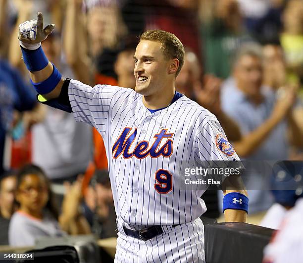 Brandon Nimmo of the New York Mets salutes the cheering fans after he hit a three run home run in the fourth inning against the Chicago Cubs at Citi...