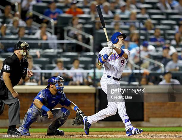 Brandon Nimmo of the New York Mets hits a three run home run in the fourth inning as Willson Contreras of the Chicago Cubs defends at Citi Field on...