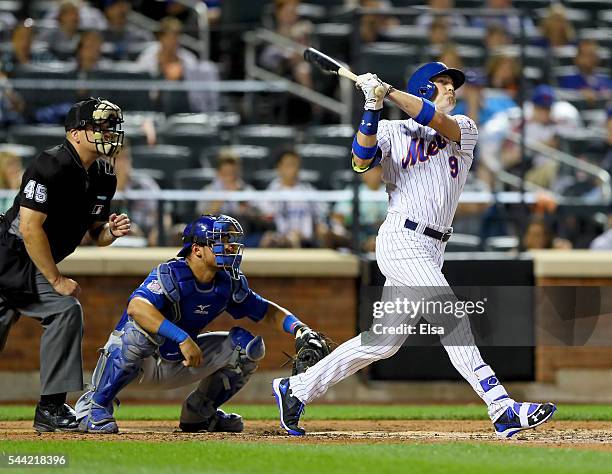 Brandon Nimmo of the New York Mets hits a three run home run in the fourth inning as Willson Contreras of the Chicago Cubs defends at Citi Field on...