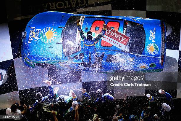 Aric Almirola, driver of the Fresh From Florida Ford, celebrates in Victory Lane after winning the NASCAR XFINITY Series Subway Firecracker 250 at...