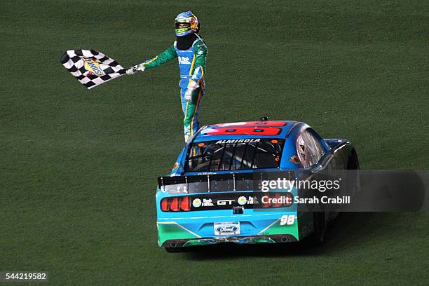 Aric Almirola, driver of the Fresh From Florida Ford, celebrates with the checkered flag on the infield after winning the NASCAR XFINITY Series...