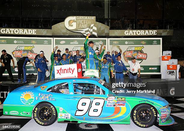 Aric Almirola, driver of the Fresh From Florida Ford, celebrates in Victory Lane after winning the NASCAR XFINITY Series Subway Firecracker 250 at...