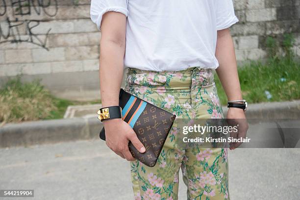 Fashion Blogger Moki Cho wears a Faith Connexion shirt, Marques Almeida trousers, Loewe bracelet and a Louis Vuitton clutch on day 1 of Paris...