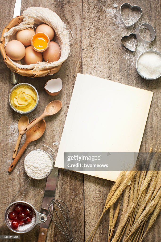 Flat lay bakery recipe card, utensils and ingredient on rustic wooden background.