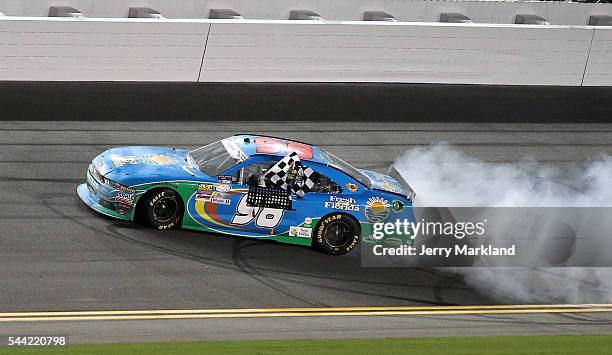 Aric Almirola, driver of the Fresh From Florida Ford, celebrates with a burnout and the checkered flag after winning the NASCAR XFINITY Series Subway...