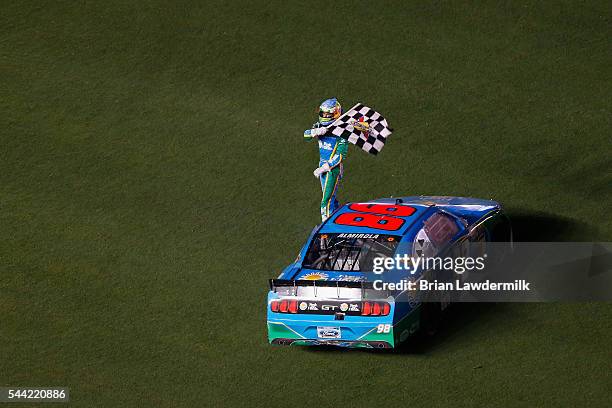 Aric Almirola, driver of the Fresh From Florida Ford, celebrates with the checkered flag on the infield after winning the NASCAR XFINITY Series...