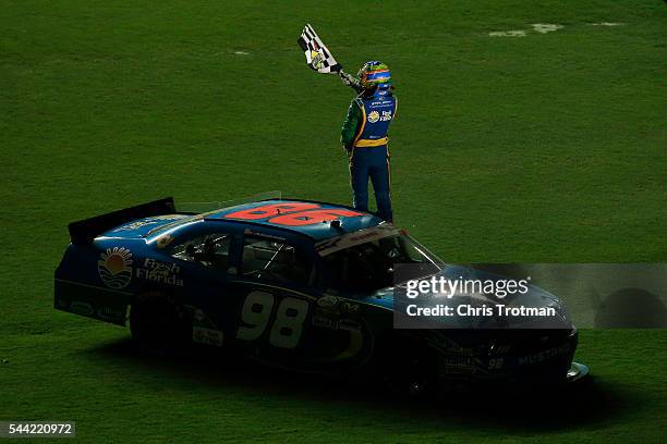 Aric Almirola, driver of the Fresh From Florida Ford, celebrates with the checkered flag on the infield after winning the NASCAR XFINITY Series...