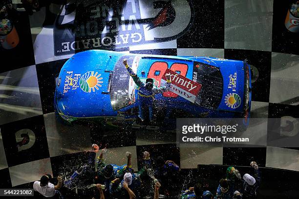 Aric Almirola, driver of the Fresh From Florida Ford, celebrates in Victory Lane after winning the NASCAR XFINITY Series Subway Firecracker 250 at...