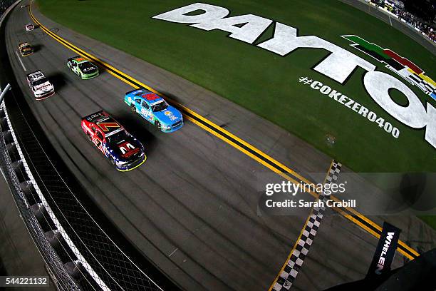 Aric Almirola, driver of the Fresh From Florida Ford, leads Justin Allgaier, driver of the TradeMark Nitrogen Chevrolet, and the rest of the field to...