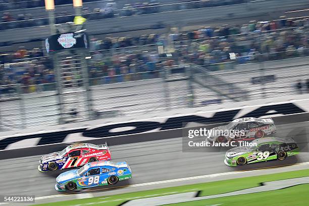 Aric Almirola, driver of the Fresh From Florida Ford, leads Justin Allgaier, driver of the TradeMark Nitrogen Chevrolet, and the rest of the field to...