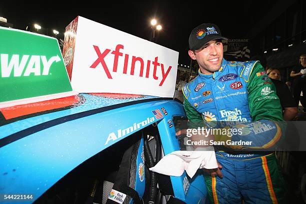 Aric Almirola, driver of the Fresh From Florida Ford, poses with the winner's decal in Victory Lane after winning the NASCAR XFINITY Series Subway...