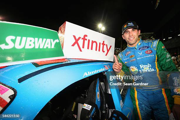 Aric Almirola, driver of the Fresh From Florida Ford, poses with the winner's decal in Victory Lane after winning the NASCAR XFINITY Series Subway...