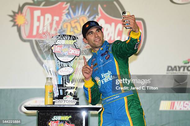 Aric Almirola, driver of the Fresh From Florida Ford, poses in Victory Lane after winning the NASCAR XFINITY Series Subway Firecracker 250 at Daytona...