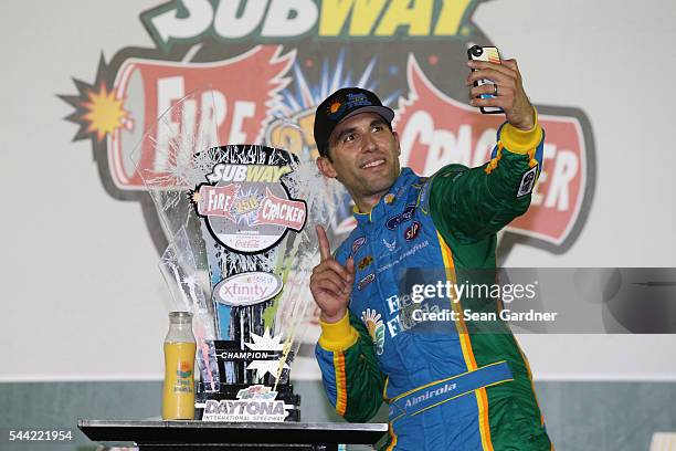 Aric Almirola, driver of the Fresh From Florida Ford, poses in Victory Lane after winning the NASCAR XFINITY Series Subway Firecracker 250 at Daytona...