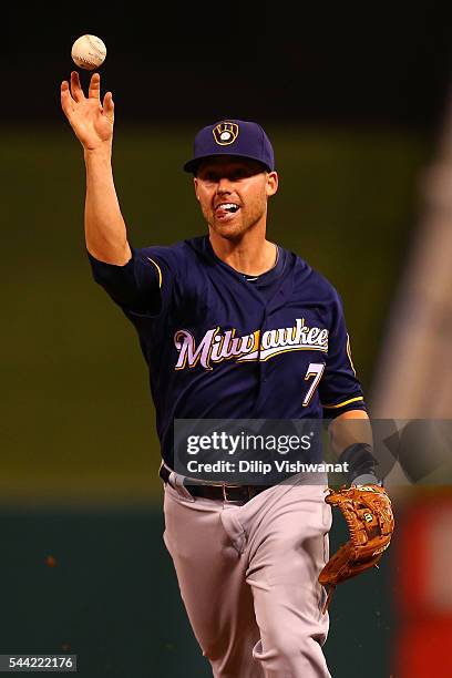 Jake Elmore of the Milwaukee Brewers flips the ball to first base for an out against the St. Louis Cardinals in the seventh inning at Busch Stadium...