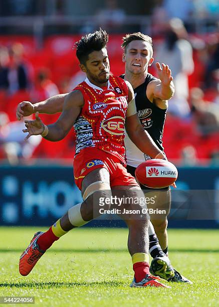 Aaron Hall of the suns gets a kick away during the round 15 AFL match between the Gold Coast Suns and the St Kilda Saints at Metricon Stadium on July...