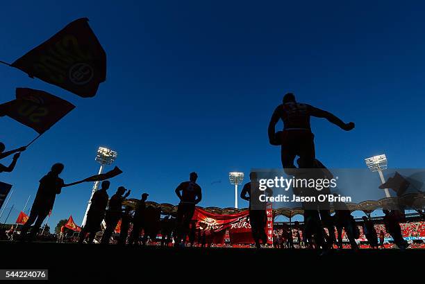 Suns players take the field during the round 15 AFL match between the Gold Coast Suns and the St Kilda Saints at Metricon Stadium on July 2, 2016 in...