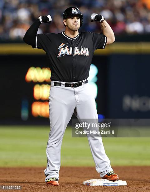 Pinch hitter Jose Fernandez of the Miami Marlins reacts after hitting a 2-run, go-ahead, game-winning double in the twelfth inning during the game...