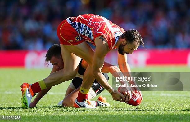 Nick Malceski of the suns contests posession during the round 15 AFL match between the Gold Coast Suns and the St Kilda Saints at Metricon Stadium on...