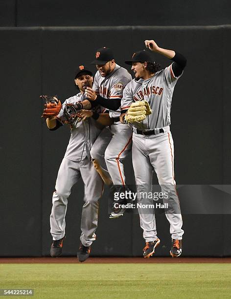 Gregor Blanco , Angel Pagan and Jarrett Parker of the San Francisco Giants celebrate a 6-4 win against the Arizona Diamondbacks at Chase Field on...