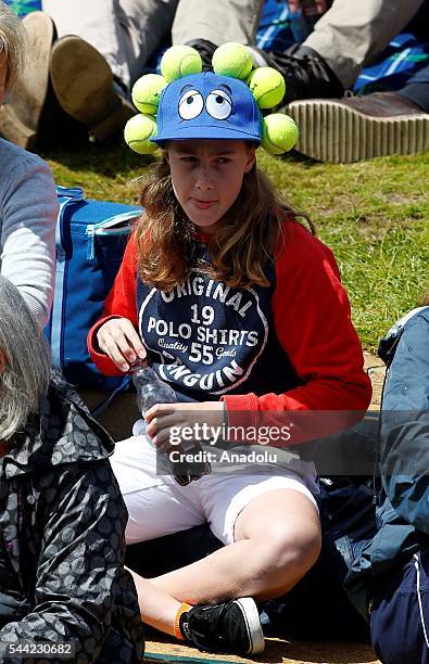 Young spectator wears a tennis ball hat on day six of the 2016 Wimbledon Championships at the All England Lawn and Croquet Club in London, United...