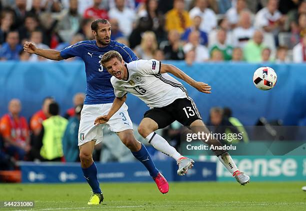 Thomas Müller of Germany in action against Giorgio Chiellini of Italy during the UEFA Euro 2016 quarter final match between Germany and Italy at...