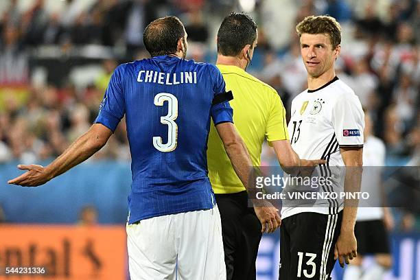 Italy's defender Giorgio Chiellini and Germany's midfielder Thomas Mueller react to Hungarian referee Viktor Kassai during the Euro 2016...