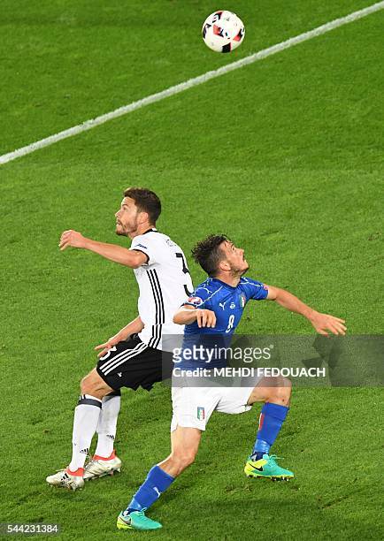 Germany's defender Jonas Hector vies for the ball with Italy's midfielder Alessandro Florenzi during the Euro 2016 quarter-final football match...