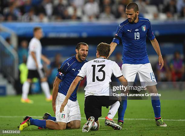 Thomas Mueller of Germany and Giorgio Chiellini of Italy aruge during the UEFA EURO 2016 quarter final match between Germany and Italy at Stade...