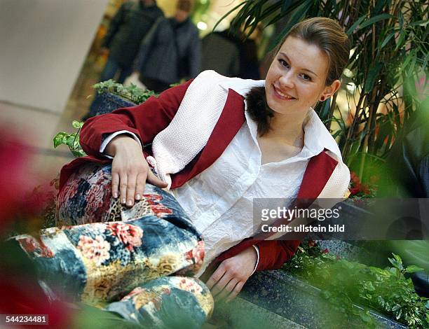 Junge Frau in Jeans, bedruckt mit Blumenmuster, und weisser Bluse in Crash-Optik- 2003