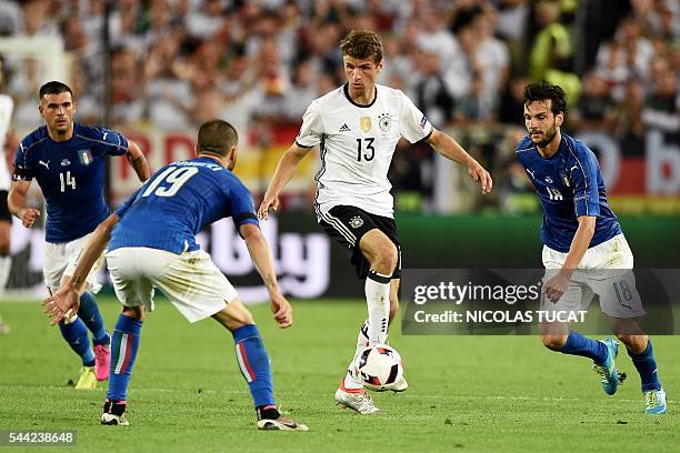 Italy's defender Leonardo Bonucci eyes the ball played by Germany's midfielder Thomas Mueller during the Euro 2016 quarter-final football match...