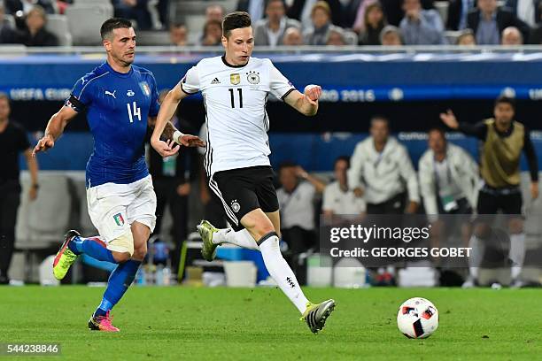 Germany's midfielder Julian Draxler vies with Italy's midfielder Stefano Sturaro during the Euro 2016 quarter-final football match between Germany...