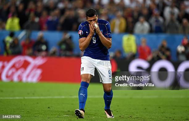 Graziano Pelle of Italy reacts after missing at the penalty shootout during the UEFA EURO 2016 quarter final match between Germany and Italy at Stade...