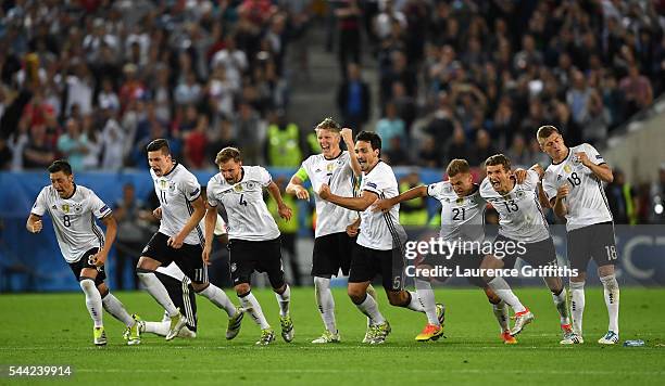 Germany players dash to celebrate their win through the penalty shootout after Jonas Hector scores to win the game after the UEFA EURO 2016 quarter...