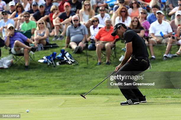 Jason Day of Australia reacts to a missed birdie putt on the 18th green during the third round of the World Golf Championships - Bridgestone...