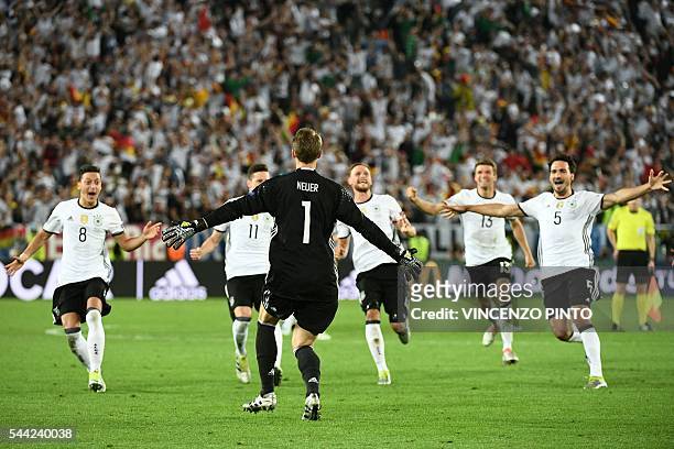 Germany players celebrate after Germany's defender Jonas Hector scored the final spot-kick in a penalty shoot-out to clinch the match for Germany in...