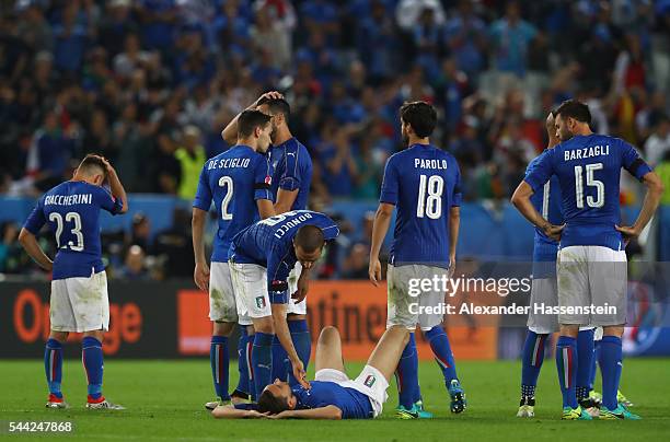 Italy players show their dejeciton after their defeat through the penalty shootout during the UEFA EURO 2016 quarter final match between Germany and...