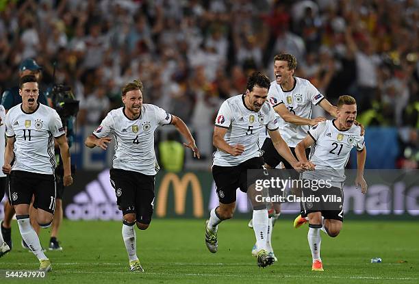 Germany players dash to celebrate their win through the penalty shootout after Jonas Hector scores to win the game after the UEFA EURO 2016 quarter...