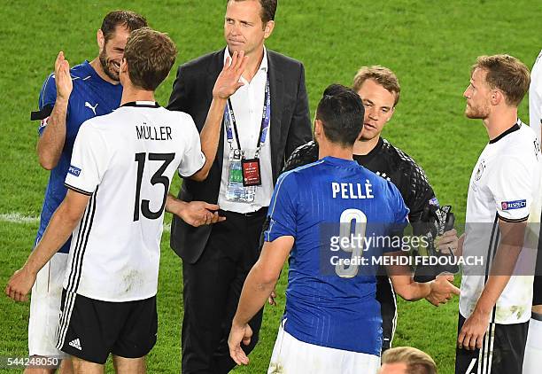 Germany's midfielder Thomas Mueller and Germany's goalkeeper Manuel Neuer shakes hands with Italy's defender Giorgio Chiellini and Italy's forward...