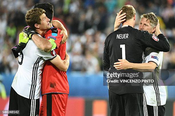 Italy's goalkeeper Gianluigi Buffon congratulates Germany's midfielder Thomas Mueller as Germany's goalkeeper Manuel Neuer celebrates with Germany's...