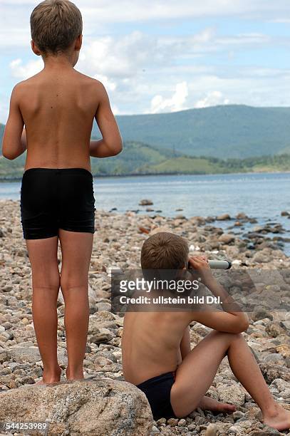 Russland - zwei Jungen mit einem Fernrohr am Baikalsee - August 2004